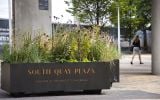 Planters can be branded in different ways; here with raised vinyl lettering.  Runners allow the planter to be moved by pallet truck.