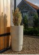 Tall round stone coloured planter