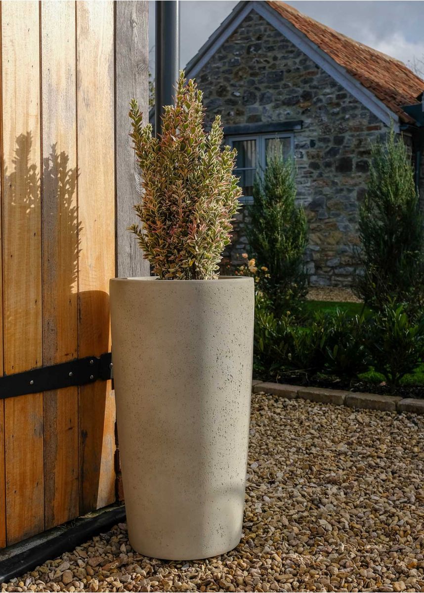 Tall round stone coloured planter