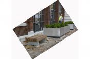 Brushed finish stainless steel planters alongside bench seating