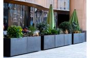 Metal outdoor planters for restaurant seating