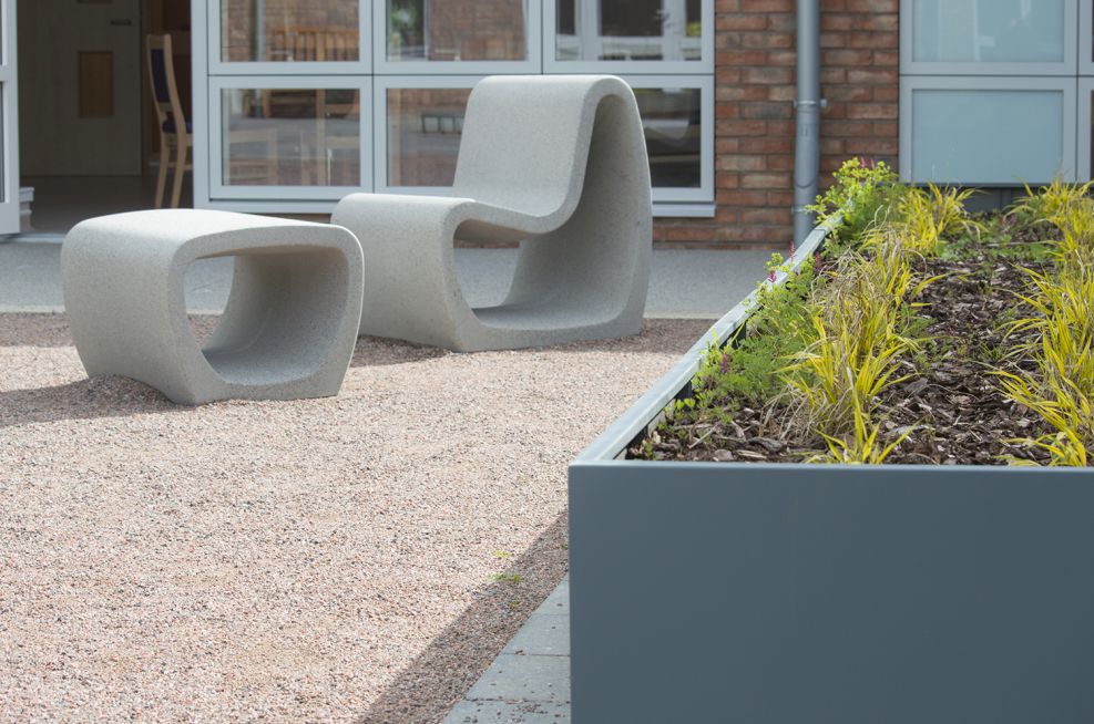 Powder coated steel planter with designer garden furniture