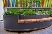 Planter with inset wooden bench seating