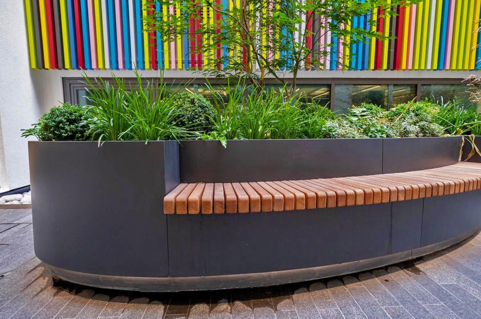 Planter with inset wooden bench seating