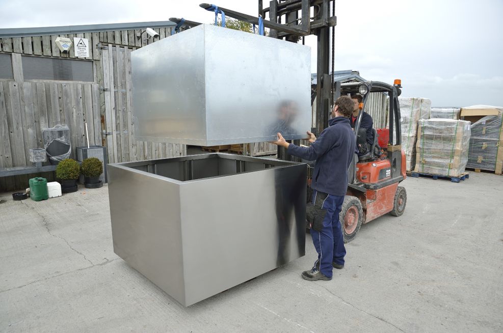 Planter Liner Being Lowered Into Steel Planters