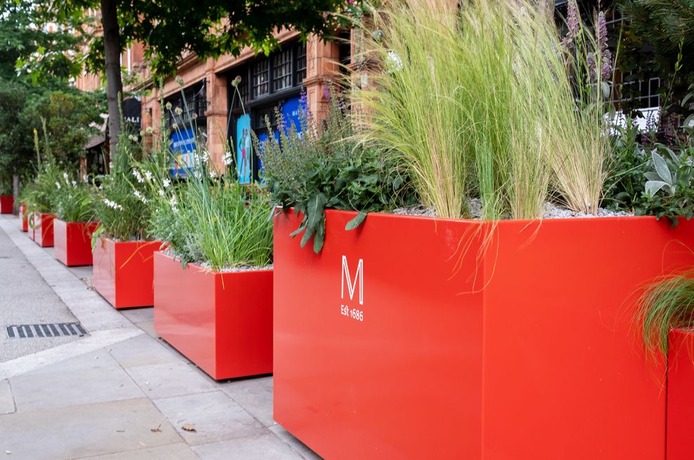 coral red street planters in Mayfair