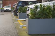 Steel Planters Used To Seperate Parking Spaces