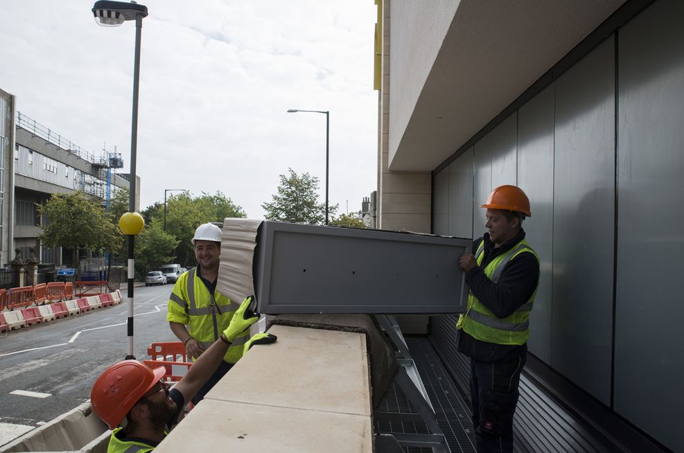 Bespoke Steel Planters With A RAL 9006 Coating Lifted Into Place